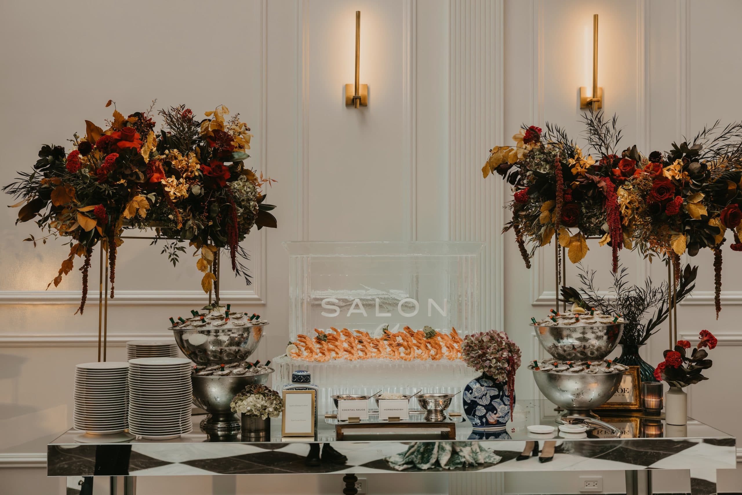 Seafood station with shrimp cocktail and oysters. Ice sculpture display that says Salon 61.